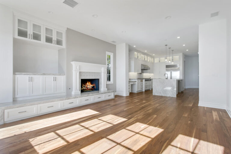 An open living space with a fireplace and kitchen.