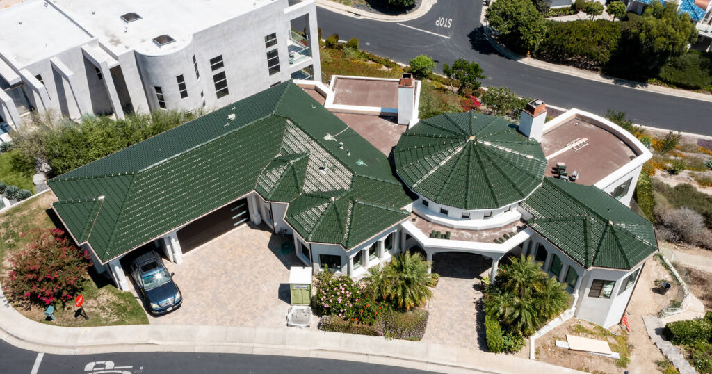 An aerial view of a house with a green roof.