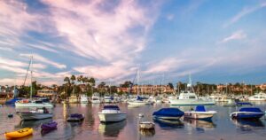 Boats docked in a harbor at sunset.