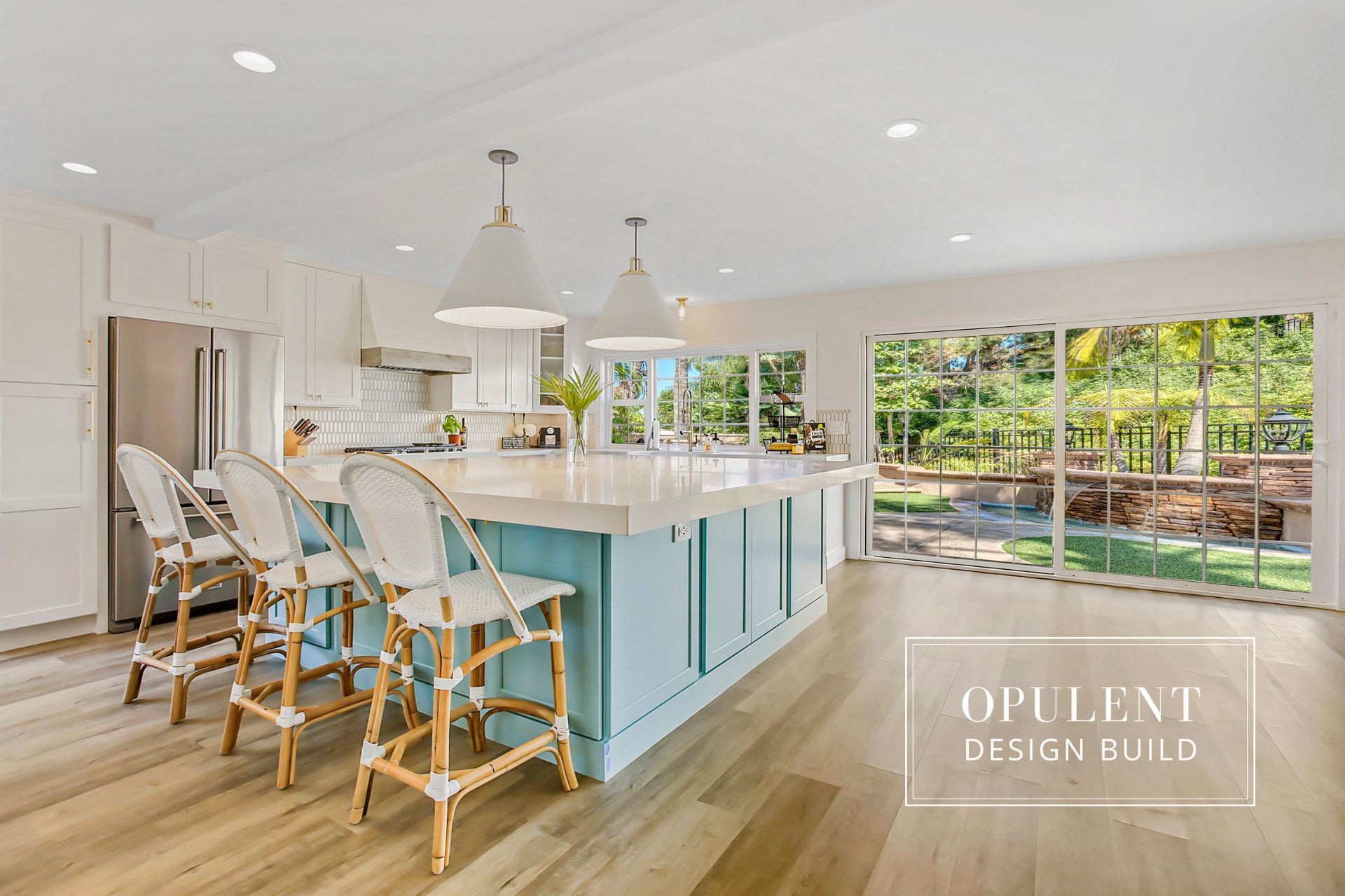 Modern kitchen with island and patio view.